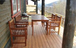 a wooden deck with a table and chairs on a cabin at Awesome Home In Hemsedal With 4 Bedrooms And Sauna in Hemsedal