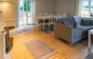 a living room with a couch and a table and chairs at Beautiful Home In Värnamo With Wifi in Värnamo