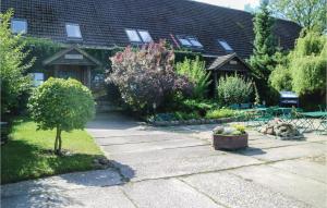 einen Garten mit einem Haus und einer Terrasse in der Unterkunft Stunning Apartment In Thulendorf-sagerheide With 2 Bedrooms in Klein Lüsewitz