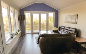 a living room with a couch and a table at Lovely Home In Trosa With Kitchen in Trosa