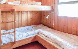 a bedroom with bunk beds in a wooden room at Beautiful Home In Trysil With 2 Bedrooms in Trysil