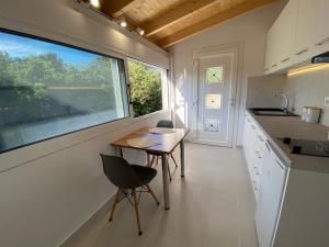 a small kitchen with a table and a window at Alexander studio in Spartià