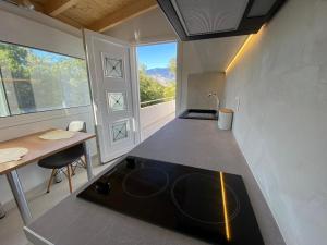 a kitchen with a stove in the middle of a room at Alexander studio in Spartià +11 photos