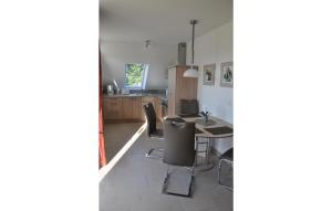 a kitchen and dining room with a table and chairs at Fewo Schloss Schwerin in Kaschow