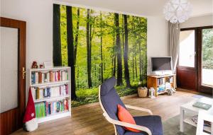 a living room with a wall mural of a forest at Rehfugium in Bad Sachsa