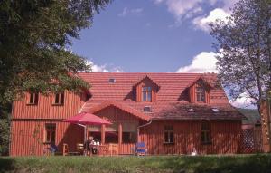 a man sitting at a table in front of a house at Stunning Home In Dautphetal With Kitchen in Amelose