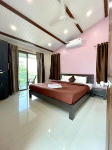 a bedroom with a bed and a pink wall at Dream House Mahabaleshwar in Mahabaleshwar +12 photos