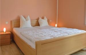 a bedroom with a bed with two pillows on it at Amazing Home In Gerolstein With Kitchen in Gerolstein
