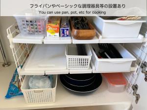 a shelf in a kitchen with some food items at BATONWORKS Naoshima in Naoshima +25 photos