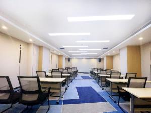 uma sala de aula vazia com mesas e cadeiras em Holiday Inn Express Hohhot East Station, an IHG Hotel em Hohhot