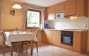 a kitchen with a table and a dining room at Amazing Apartment In Winterberg-altenfeld With 2 Bedrooms And Wifi in Winterberg