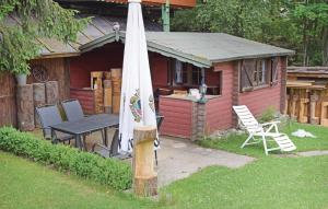 an umbrella and a table and a house at Nice Apartment In Winterberg-Altenfeld in Winterberg +6 photos