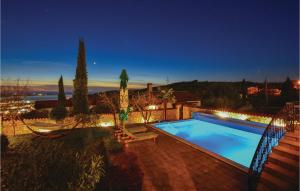 a swimming pool in a yard at night at Lovely Home In Izola With Kitchen in Malija