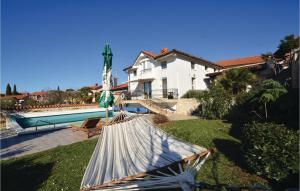 a house with a swimming pool in the yard at Lovely Home In Izola With Kitchen in Malija +31 photos