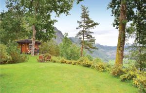 una cabaña en medio de un campo con césped en Nice Home In Norheimsund With House A Mountain View en Norheimsund