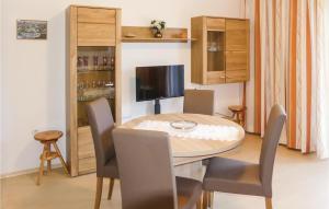 a dining room with a table and chairs at Lovely Apartment In Sattendorf With Lake View in Sattendorf