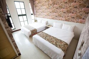 Postel nebo postele na pokoji v ubytování Jia-Jia Business Hotel