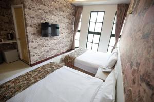 Postel nebo postele na pokoji v ubytování Jia-Jia Business Hotel