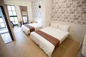 Postel nebo postele na pokoji v ubytování Jia-Jia Business Hotel