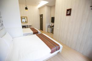 Postel nebo postele na pokoji v ubytování Jia-Jia Business Hotel