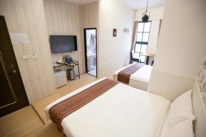 Postel nebo postele na pokoji v ubytování Jia-Jia Business Hotel