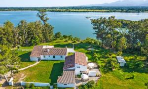 an aerial view of a house on the shore of a lake at Locations "ChezChristine Aléria" à Aléria in Aléria