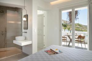 a bedroom with a bathroom with a shower and a sink at Arkasa Palace in Arkasa