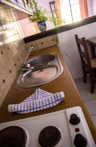 a kitchen counter with a sink next to a sink at Hesperia Hotel in Karlovasi