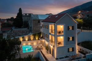 a house with a swimming pool at night at Villa Mirta in Bol