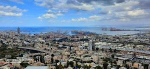 an aerial view of a city and the water at יחידות אירוח נוף המפרץ in Haifa