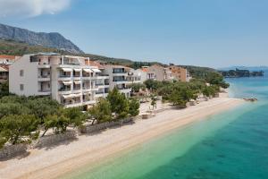 a view of a beach with buildings and the water at Luxury Penthouse - Big Blue in Tučepi