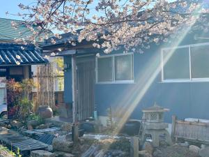 a blue house with a beam of sunlight coming into it at Hanatsu in Tamano