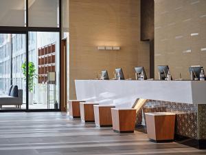 a lobby with a reception desk and chairs at Roynet Hotel Seoul Mapo in Seoul