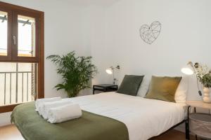 a bedroom with a large bed and a window at CASA PALACIO SUR in El Puerto de Santa María