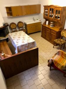 a kitchen with a bed and a table and chairs at Casa Tiziana in Lavena Ponte Tresa