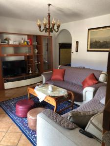 a living room with a couch and a table at Casa Tiziana in Lavena Ponte Tresa