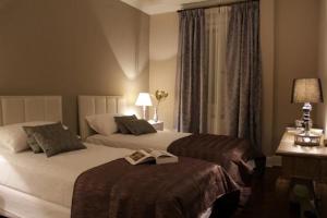 Un pat sau paturi într-o cameră la Mito Casa Hotel