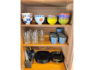 a shelf with bowls and plates and cups on it at Ninja Hotel Kamakura - Vacation STAY 58171v in Kamakura