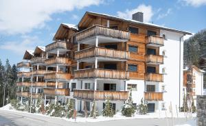 a building with balconies on the side of it at Alpine chic apartment at Rothorn cable car in Lenzerheide +12 photos