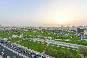 a highway in a city with a lot of cars at Al Mansour Suites Hotel in Doha