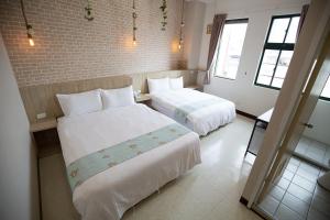 Postel nebo postele na pokoji v ubytování Jia-Jia Business Hotel