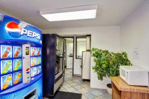 a pepsi machine in an office with a refrigerator at Knights Inn Burlington NC in Burlington