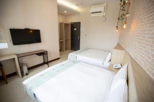 Postel nebo postele na pokoji v ubytování Jia-Jia Business Hotel