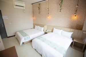 Postel nebo postele na pokoji v ubytování Jia-Jia Business Hotel