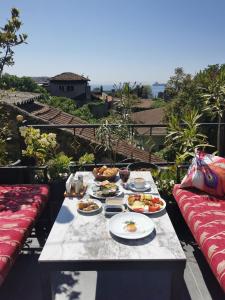 a table with plates of food on a balcony at Apple Tree Hotel in Istanbul