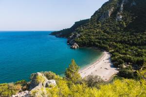 a beach on the side of a mountain at Olympos Orange Bungalows in Olympos