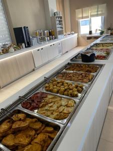 a buffet line with many different types of food at Siviris Golden Beach in Siviri