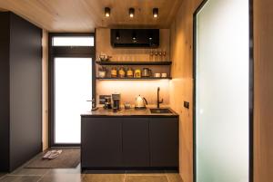 a kitchen with a black counter and a window at ÖÖD Hötels Roosisaare – with sauna in Roosisaare
