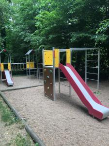 a playground with a slide in a park at L'étape de la Tour in Grand-Fougeray