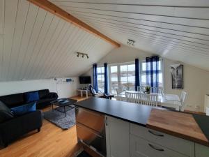 a kitchen and living room with a large counter top at Lauvøy Feriesenter in Askøy